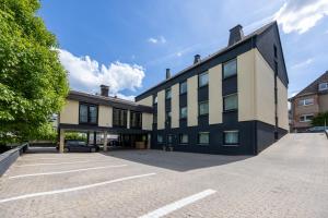 a building with a car parked in a parking lot at Hotel Am Martinsberg in Andernach