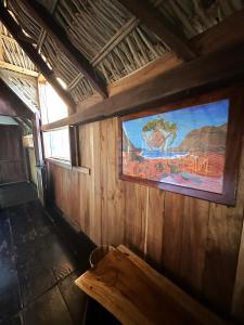 a room with a large painting on the wall of a house at Casa playa del Amor in San Pedro Pochutla