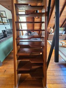 a wooden spiral staircase in a house at Recanto do Guará Cabana in Capitólio