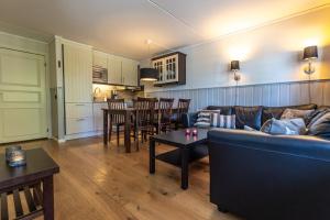 a living room with a couch and a table at Gula Byn 410 in Sälen