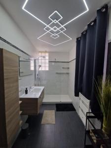 a bathroom with a tub and a sink and a shower at Residence Chateau d Eau in Mitry-Mory +3 photos