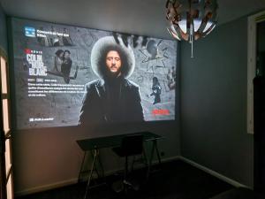 a large poster of a man in a hat on a wall at Residence Chateau d Eau in Mitry-Mory