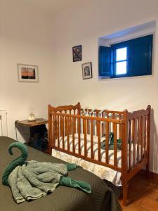 two wooden cribs in a bedroom with a window at Monte da Rochela in Vila Viçosa +28 photos