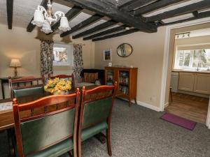 a living room with a table and chairs at Penlone Cottage in Rhayader