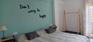 a bedroom with a bed with a heart on the wall at Apartamento Les Fonts in Polop