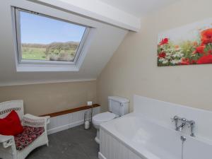 a bathroom with a toilet and a window at Penlone Cottage in Rhayader +29 photos