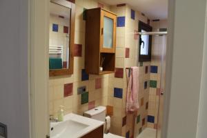 a bathroom with a sink and a toilet and a mirror at Casa Mila in Etayo +22 photos