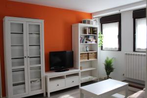 a living room with a tv and a white cabinet at Casa Mila in Etayo