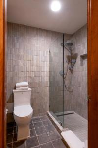 a bathroom with a toilet and a glass shower at Hotel Chimayo de Santa Fe in Santa Fe +30 photos