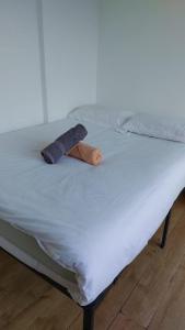 a bed with two towels on top of it at Newbury 2 in London