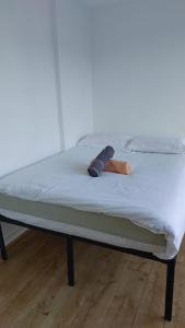 a bed with two mitts on top of it at Newbury 2 in London