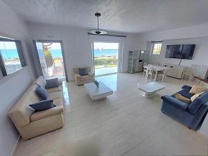 a large living room with couches and a dining room at Saroné Villa in Anavyssos