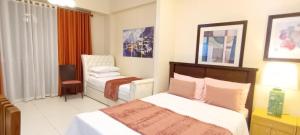 a hotel room with a bed and a chair at Shirley Pico de Loro 1BR in Nasugbu