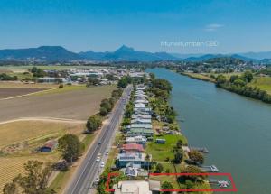 an aerial view of a row of houses next to a river at Tweed River Waterfront Cottage in Murwillumbah