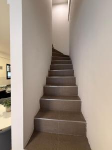 a stairway leading up to a building with white walls at Work & Stay Zarate in Zárate