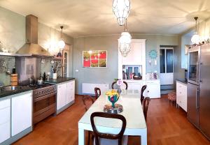 a kitchen with a table and chairs in a room at Villa CALVI Lago Maggiore in Premeno