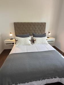 a bedroom with a large bed with two night stands at Work & Stay Zarate in Zárate