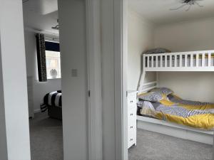a childs bedroom with a bunk bed and a bunk bed at Palm Tree House in Filey