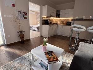 a living room with a couch and a table at Milano Vendégház in Bakonybél