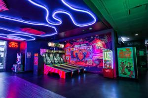 a room with a video game room with arcade machines at Oasis at Gold Spike in Las Vegas