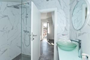a bathroom with a sink and a glass shower at Core of Hvar Old Town in Hvar