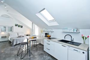 a kitchen with a sink and a bedroom with a bed at Core of Hvar Old Town in Hvar