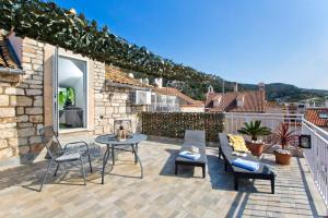 a patio with a table and chairs and a fireplace at Core of Hvar Old Town in Hvar