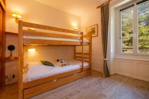 a bedroom with two bunk beds and a window at Résidence Bel'Alp in Chamonix +17 photos