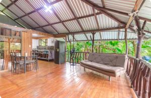 a living room with a couch and a table at Sloth House Rio Celeste in Rio Celeste