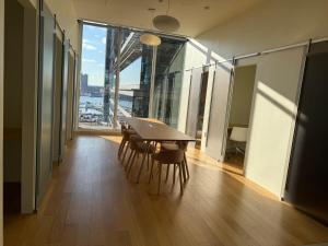 a dining room with a table and chairs and a large window at Luxe Apartment with Harbor views in Baltimore