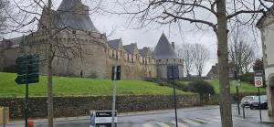 a building with turrets on the side of a street at Elsa in Pontivy