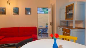 a living room with a red couch and a table at CRema Beach in Palmi