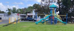 a playground with a slide in a park at Villa Zoed in San Juan
