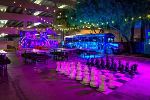 a large chess board in front of a bus with purple lights at Oasis at Gold Spike in Las Vegas