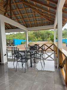 a group of tables and chairs on a patio at Hotel Rincón Samaná in Las Galeras