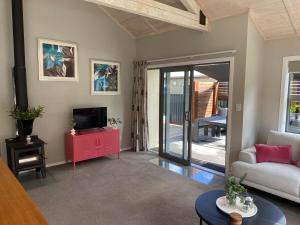 a living room with a couch and a tv at Sunny Clyde Getaway in the Heart of Clyde in Clyde