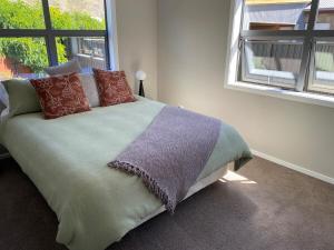a bedroom with a bed with pillows and a window at Sunny Clyde Getaway in the Heart of Clyde in Clyde