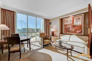 a living room with a couch and a table and a desk at MGM Signature 03-818 Jacuzzi Studio in Las Vegas