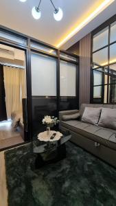 a living room with a couch and a table at Cozy Sunset Condo Thompson Stay in Manila +31 photos