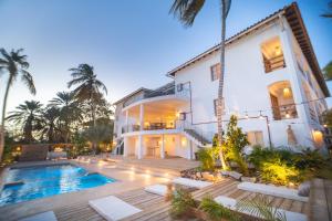 an exterior view of a house with a swimming pool at Hotel Kokua Boutique in El Yaque