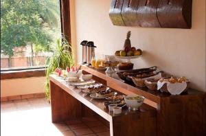 a kitchen counter with a bunch of food on it at Pousada Vila Leopoldina in Tiradentes
