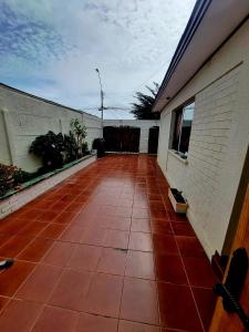 a porch of a house with a red tile floor at Alojamiento La Serena CQ in La Serena