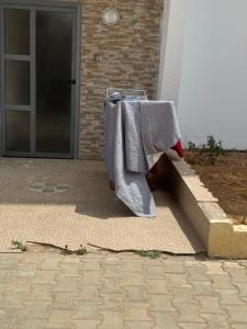 a table with a towel on it in front of a door at Sable d or Mansoria in Aïn Harrouda