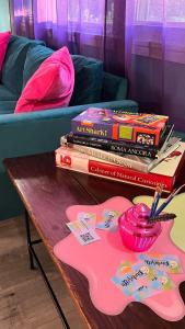 a table with a pile of books on top of it at Casa Pinturella in Silver Spring