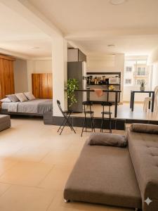 a living room with two beds and a table at Pilarica Gardens in Medellín