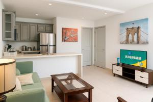 a kitchen and living room with a couch and a table at Yellow house Whole 2bedrooms in Alhambra in Alhambra