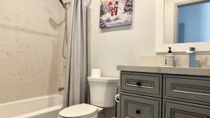 a bathroom with a toilet and a sink and a shower at Yellow house Whole 2bedrooms in Alhambra in Alhambra +6 photos
