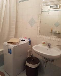 a bathroom with a sink and a toilet and a mirror at LA COLLINETTA appartamento di vacanza in Collina d'Oro +36 photos