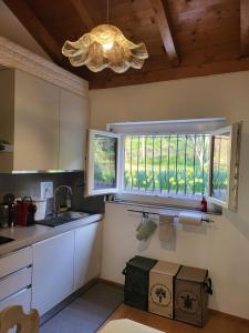 a kitchen with a sink and a window at LA COLLINETTA appartamento di vacanza in Collina d'Oro
