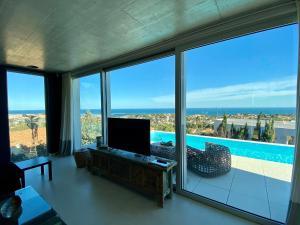 a living room with a view of the ocean at Villa Infinity Denia in Denia